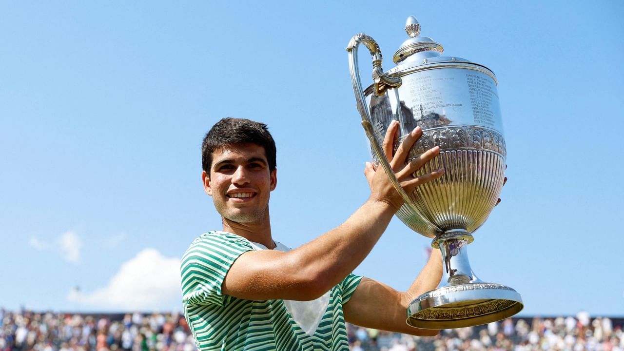 Spain's Carlos Alcaraz celebrates with the trophy after winning his final match against Australia's Alex de Minaur. Credit: Action Images via Reuters Photo