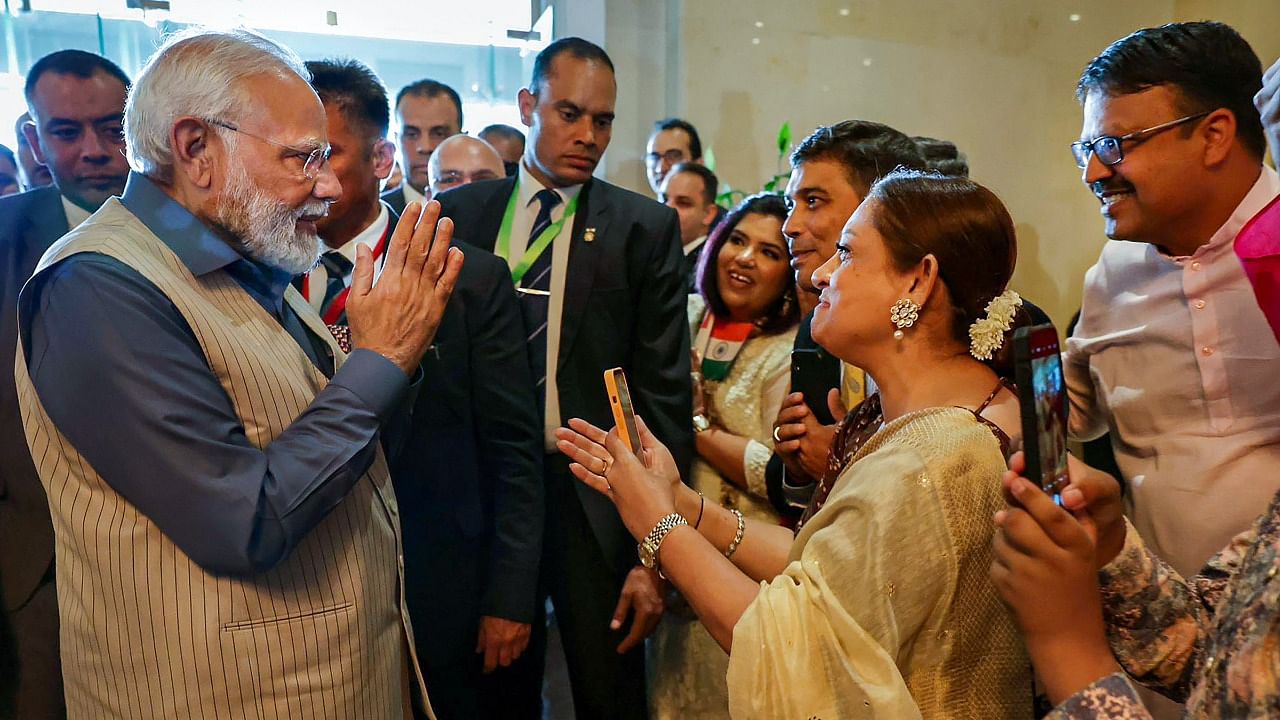 Prime Minister Narendra Modi interacts with the Indian diaspora upon his arrival in Cairo. Credit: PTI Photo