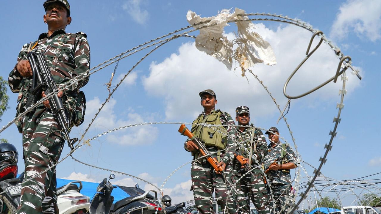 Security personnel stand guard ahead of the Amarnath Yatra 2023, at the Bhagwati Nagar base camp in Jammu. Credit: PTI Photo