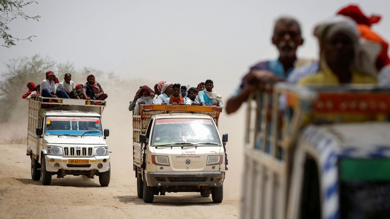 People travel in vehicles as they leave from a cremation ground on a hot summer day in Ballia District in the northern state of Uttar Pradesh. Credit: Reuters Photo