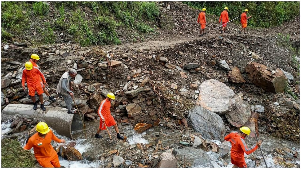 NDRF personnel conduct a search operation for a woman missing after flash flood, at Baggi Nala in Mandi, Monday, June 26, 2023. Credit: PTI Photo