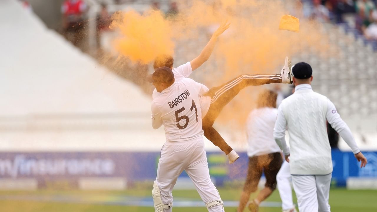 England's Jonny Bairstow carries a just stop oil protester off the field. Credit: Twitter/@cricketcomaus