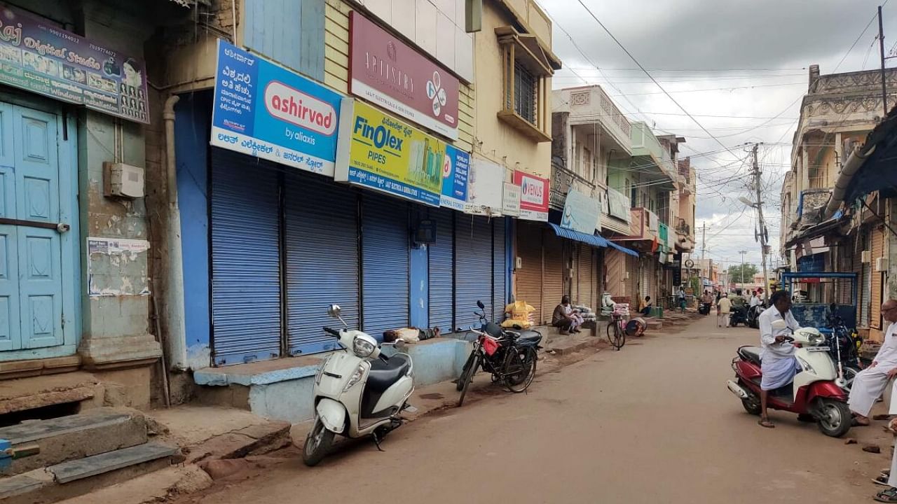 Traders down shutters in view of the bandh called by weavers and other organisations in protest against power tariff hike, in Banahatti, Bagalkot district, on Wednesday. Credit: Special Arrangement