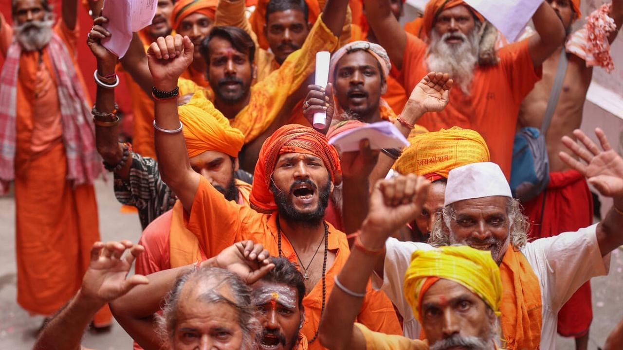 Sadhus wait to get themselves registered for the Amarnath Yatra 2023, at Ram Mandir base camp in Jammu, Friday, June 30, 2023. Credit: PTI Photo