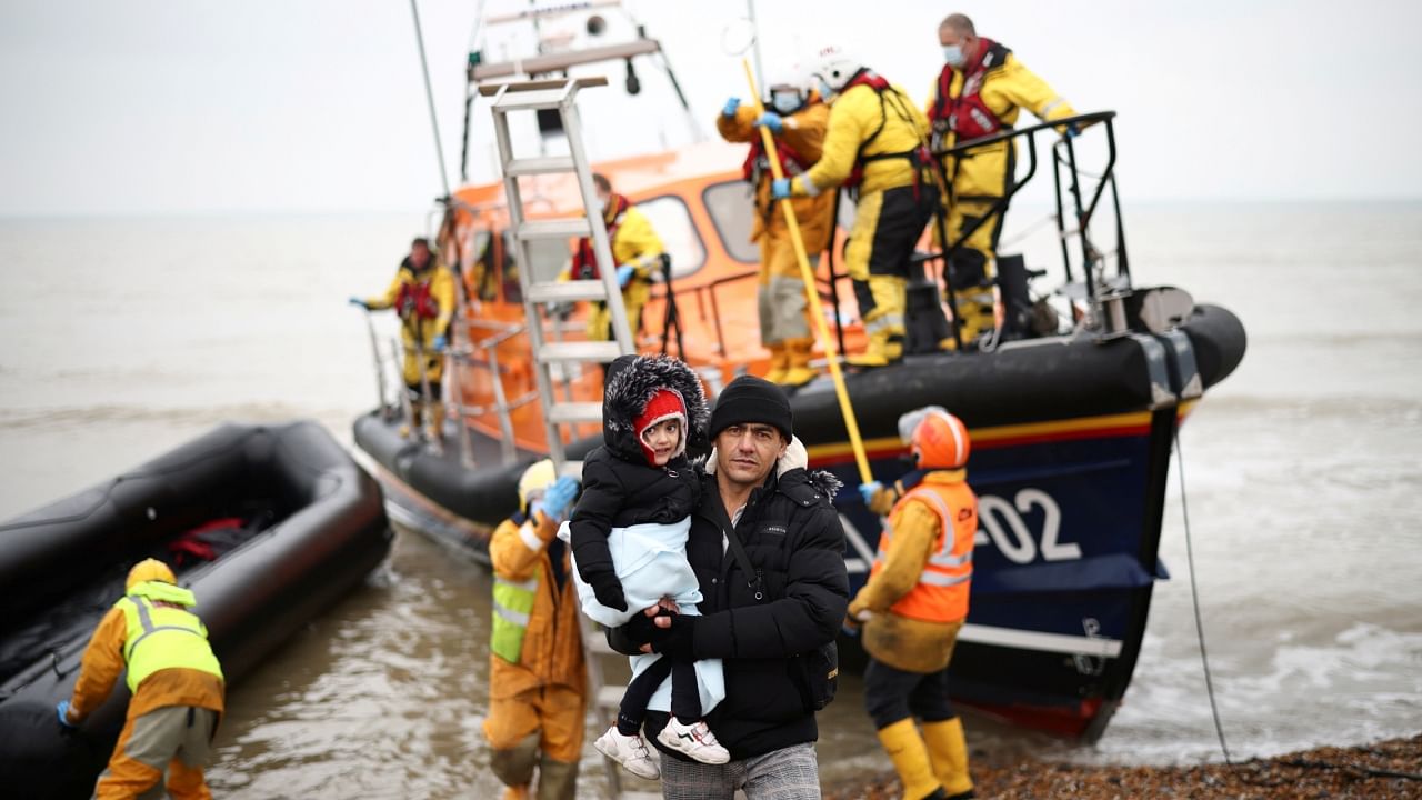 Migrants are brought ashore onboard a RNLI Lifeboat, after having crossed the channel, in Dungeness, Britain, November 24, 2021. Credit: Reuters File Photo