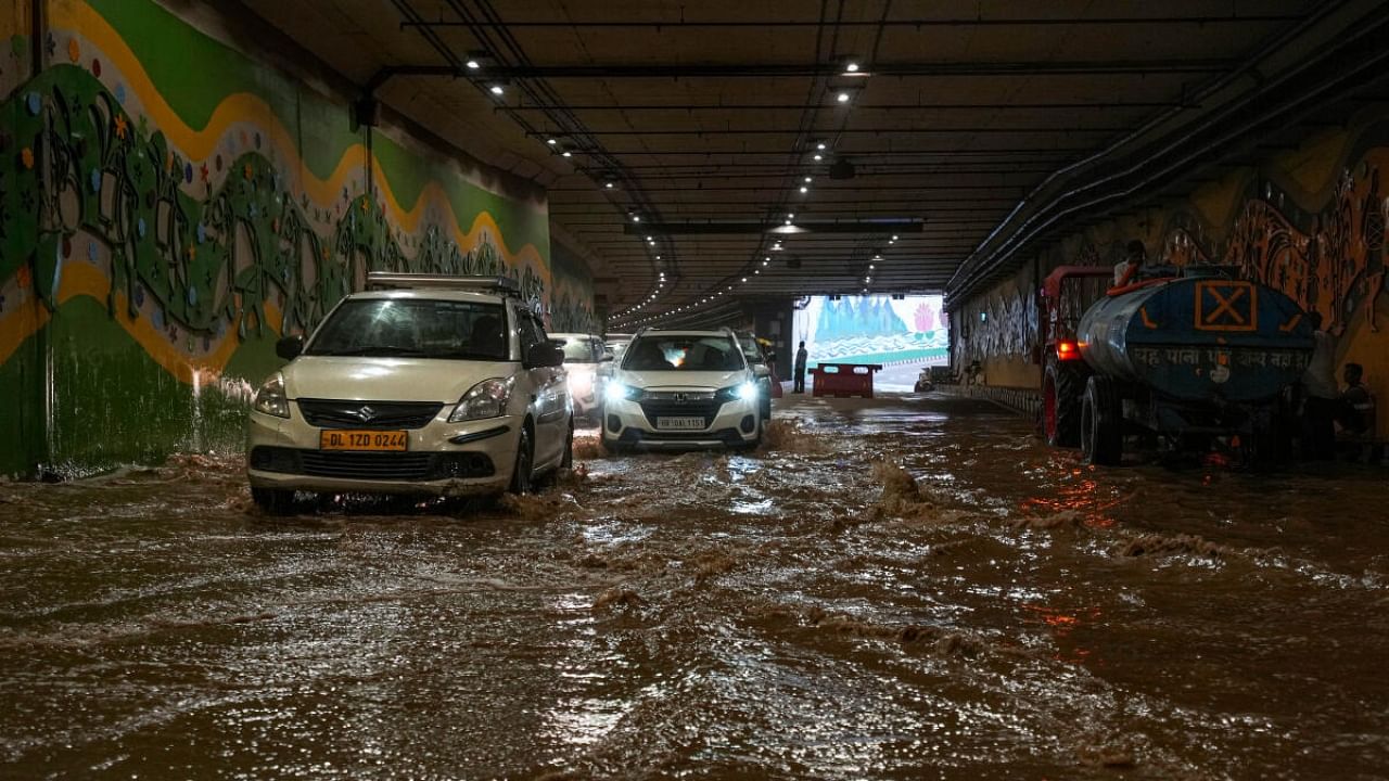 Vehicles wade through a waterlogged road after the monsoon rains, at Pragati Maidan tunnel in New Delhi, Friday, June 30, 2023. Credit: PTI Photo