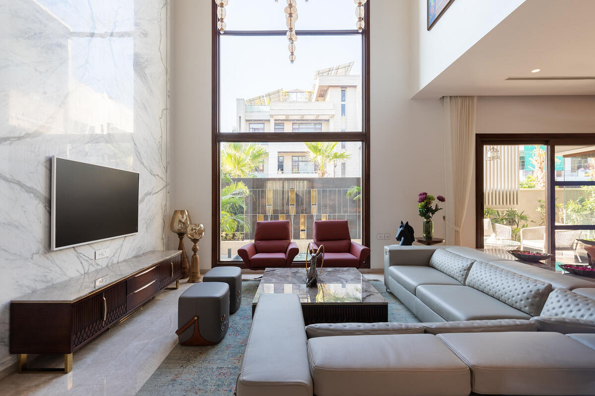 A living area with a full-length window by Design Square, Jaipur.
