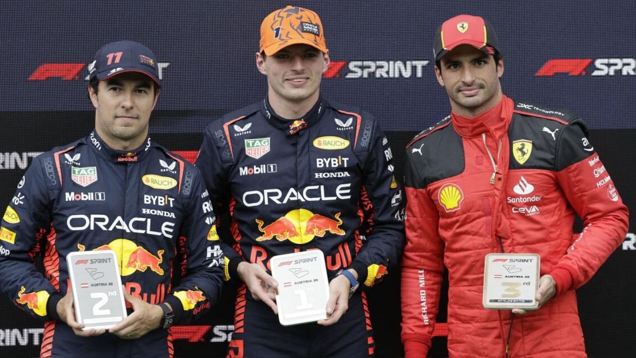  Red Bull's Max Verstappen celebrates after winning the sprint race alongside second place Red Bull's Sergio Perez and third place Ferrari's Carlos Sainz Jr. Credit: Reuters Photo