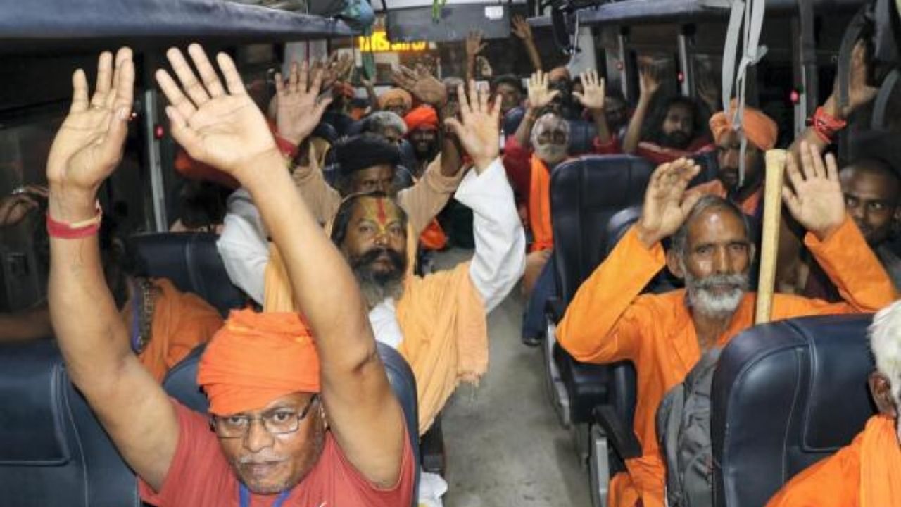 Pilgrims raise religious slogans after boarding a bus as they leave for the Amarnath Yatra 2023. Credit: PTI Photo