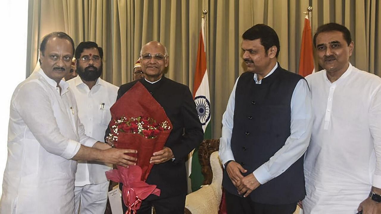 Maharashtra Governor Ramesh Bais with the newly-sworn in Deputy Chief Minister Ajit Pawar after administering him oath of office, at Raj Bhavan in Mumbai, Sunday, July 2, 2023. Maharashtra Chief Minister Eknath Shinde, deputy CM Devendra Fadnavis and NCP leader Praful Patel are also seen. Credit: PTI Photo