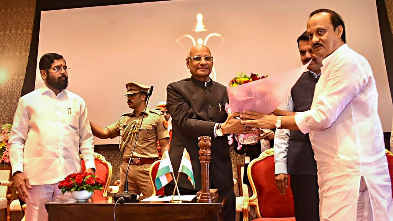 Maharashtra Governor Ramesh Bais congratulates the newly sworn-in Deputy Chief Minister Ajit Pawar during a ceremony at Raj Bhavan, in Mumbai, Sunday, July 2, 2023. Maharashtra Chief Minister Eknath Shinde and Deputy Chief Minister Devendra Fadnavis are also seen. Credit: PTI Photo