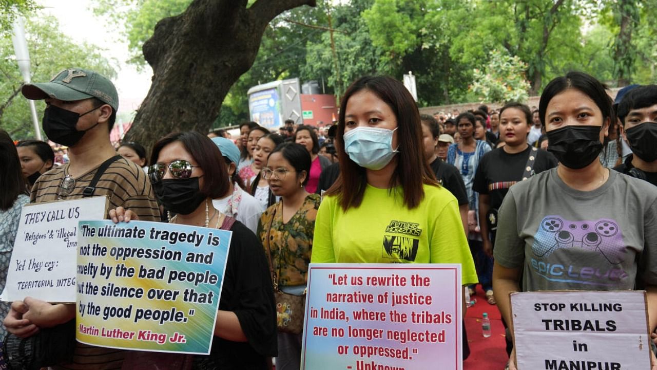 Manipuri locals along with members of various civil societies stage a protest over the ongoing violence in the state. credit: PTI File Photo