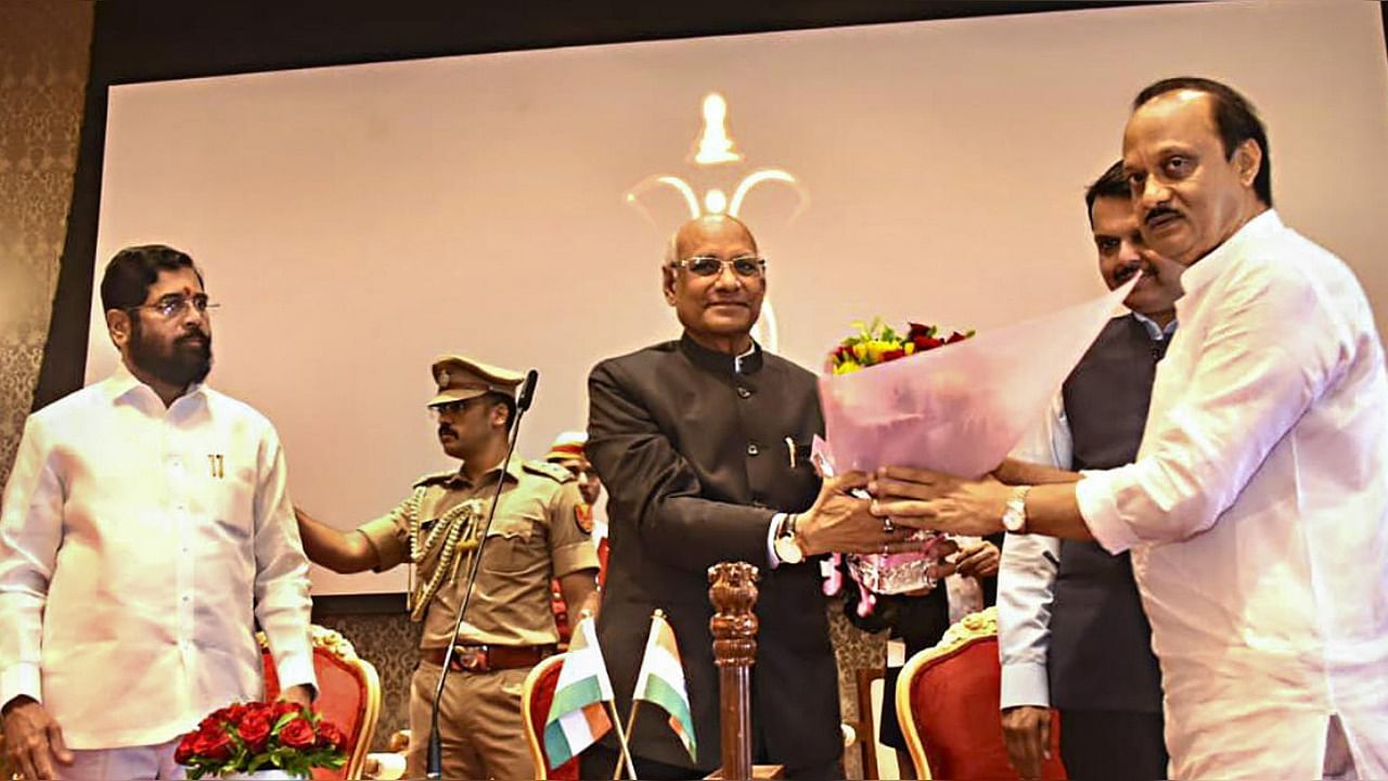 Maharashtra Governor Ramesh Bais congratulates the newly sworn-in Deputy CM Ajit Pawar during a ceremony at Raj Bhavan. Credit: PTI Photo