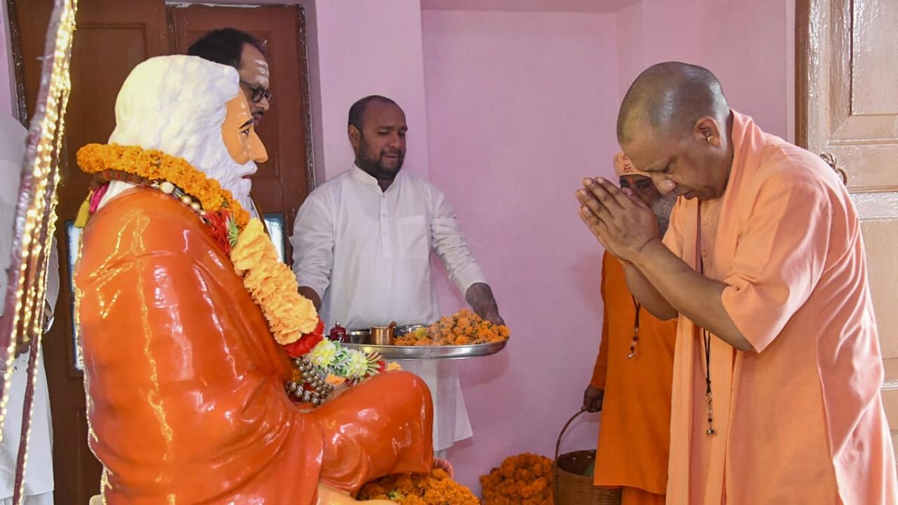 Uttar Pradesh Chief Minister Yogi Adityanath offers prayers on the occasion of 'Guru Purnima', in Gorakhpur. Credit: PTI Photo