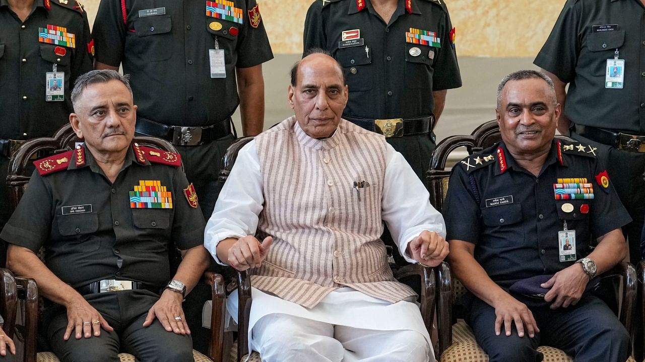 Defence Minister Rajnath Singh flanked by Chief of Army Staff General Manoj Pande, right, and Chief of Defence Staff of the Indian Armed Forces Anil Chauhan at the 75th anniversary event of ‘UN Peacekeepers Day’, in New Delhi, Tuesday, June 13, 2023. Credit: PTI Photo