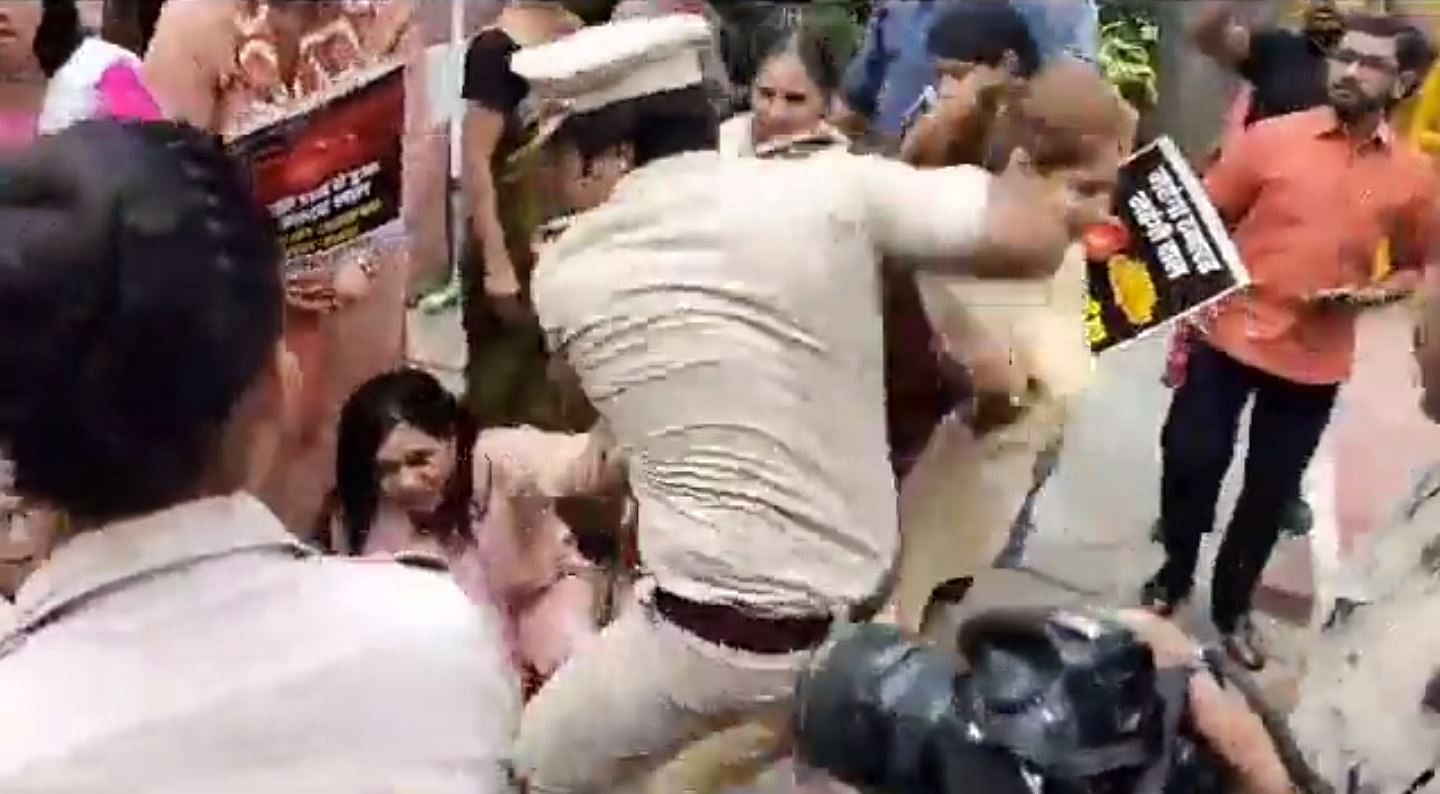 Screengrab from a video shared by the Congress shows a male Delhi Police officer manhandling a Mahila Congress member. Credit: Twitter/@INCIndia