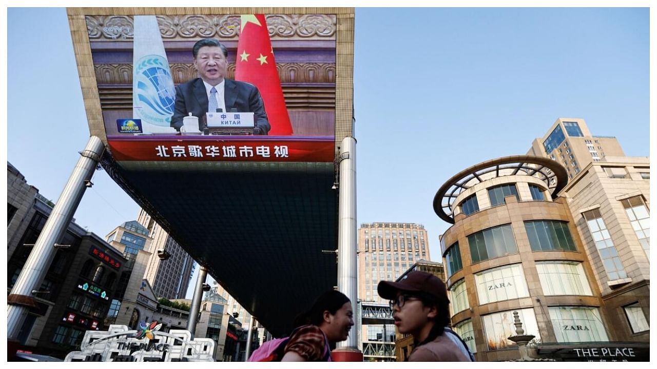 Giant screen broadcasts news footage of Chinese President Xi Jinping attending via video link the meeting of the SCO, in Beijing, July 4, 2023. Credit: Reuters Photo