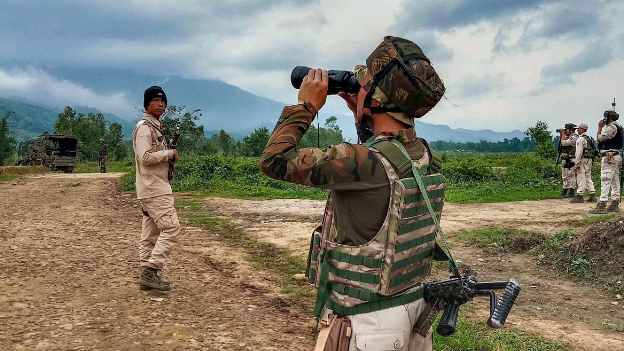 Security personnel patrol at a violence-hit area in Irengbam village of Bishnupur district. Credit: PTI Photo