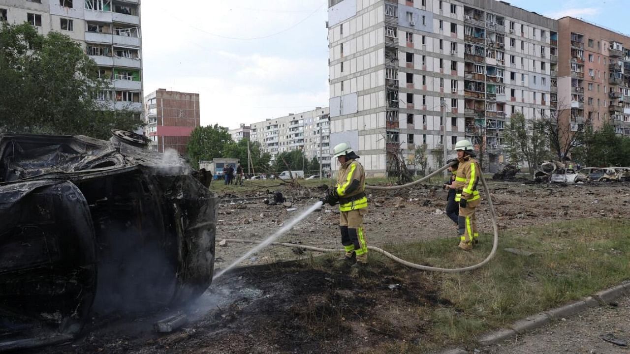 Firefighters work at a site of a Russian military strike in the town of Pervomaiskyi in Ukraine's Kharkiv. Credit: Reuters Photo