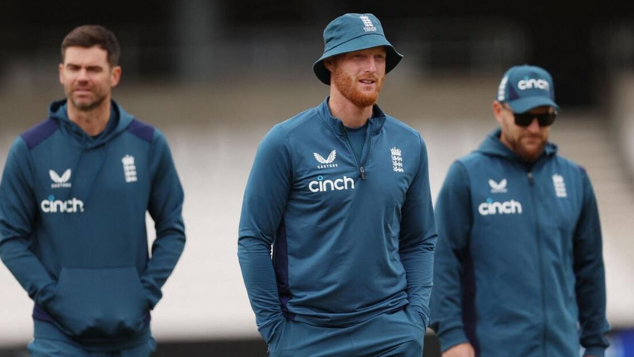 England's Ben Stokes with James Anderson and head coach Brendon McCullum during practice 