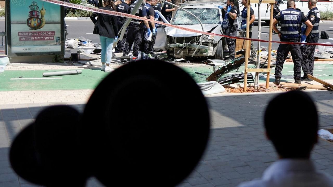 People watch as Israeli police work at the scene of a ramming attack in Tel Aviv, Israel July 4, 2023. Credit: Reuters Photo