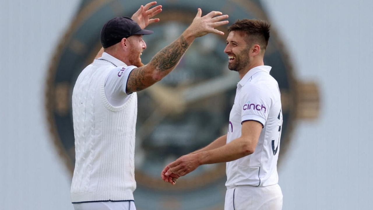 England's Mark Wood celebrates with Ben Stokes after taking the wicket of Australia's Todd Murphy. Credit: Reuters Photo