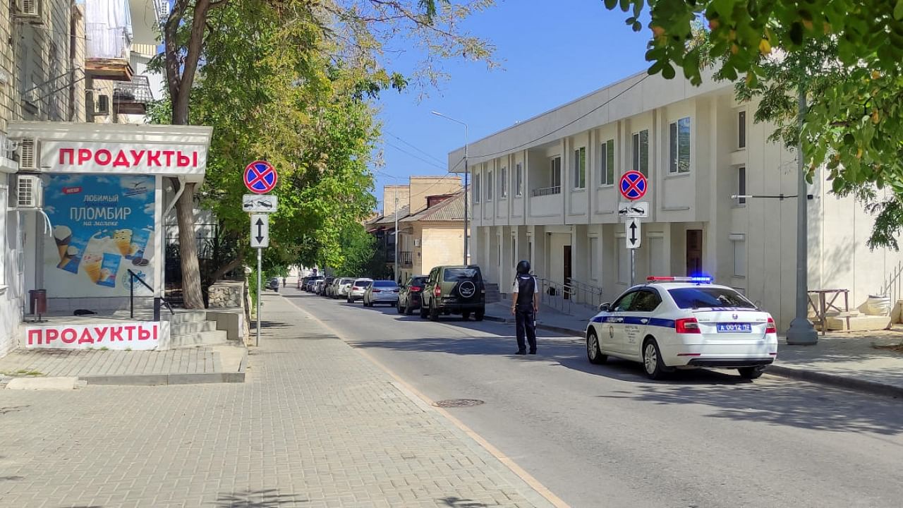 A law enforcement officer stands guard in a street following a reported combat drone attack on the Russian Black Sea Fleet's headquarters in Sevastopol, Crimea August 20, 2022. Credit: Reuters File Photo