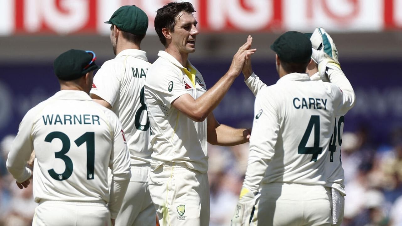 Australia's Pat Cummins celebrates with teammates after taking the wicket of England's Stuart Broad caught by Steve Smith. Credit: Reuters Photo