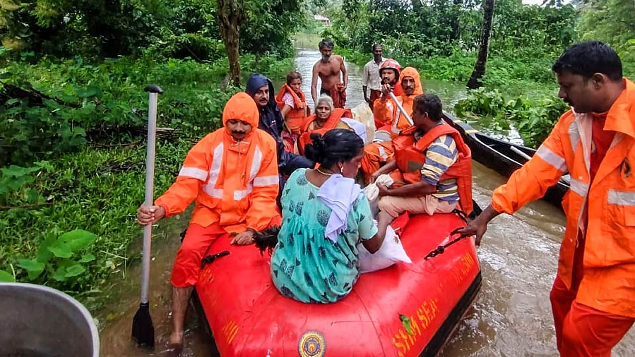 Fire brigade personnel evacuate a family stranded due to floods following rains in Punnathura of Kottayam district, Thursday, July 6, 2023. Credit: PTI File Photo