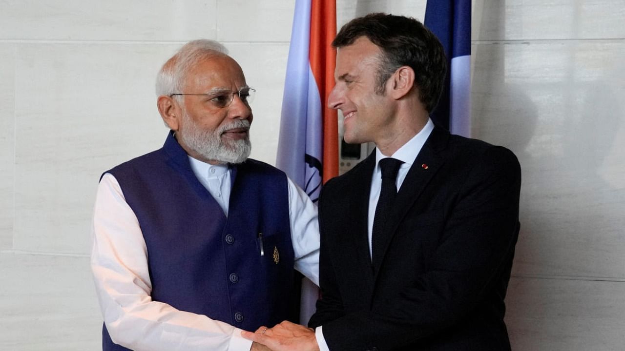 Prime Minister Narendra Modi and French President Emmanuel Macron shake hands during a bilateral meeting on the sidelines of the G20 Summit in Nusa Dua, Bali, Indonesia, on Wednesday November 16, 2022. Credit: Reuters Photo