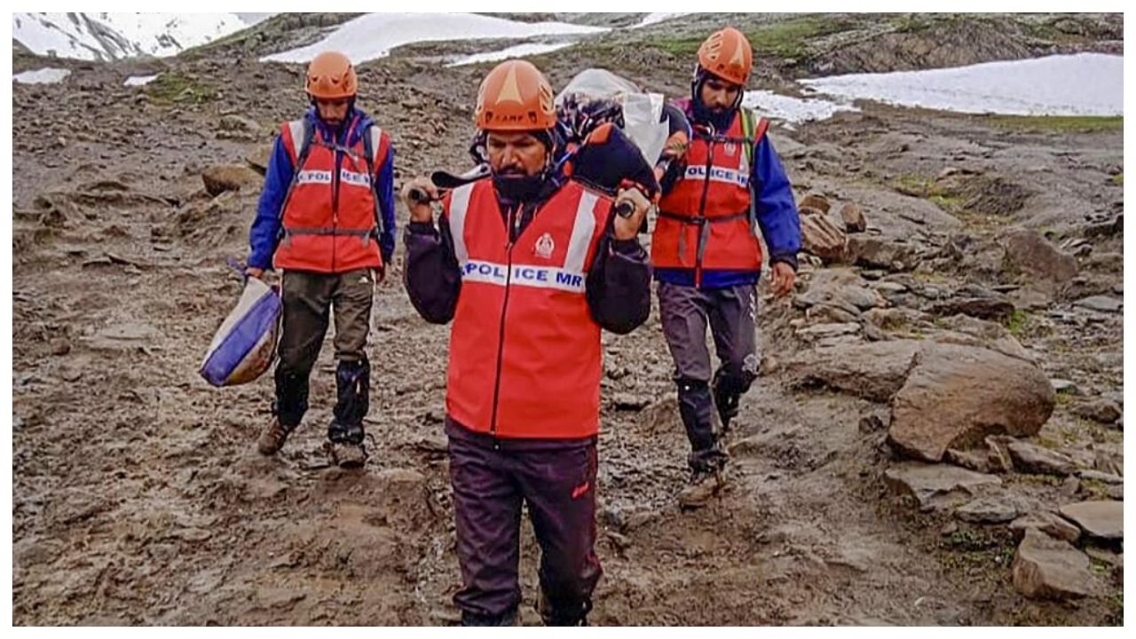 Jammu and Kashmir (J&K) Police’s Mountaineering Rescue Team (MRT) personnel rescue an Amarnath Yatra pilgrim after snow fall at the MG Top in Pahalgam, Saturday, July 8, 2023. Credit: PTI Photo