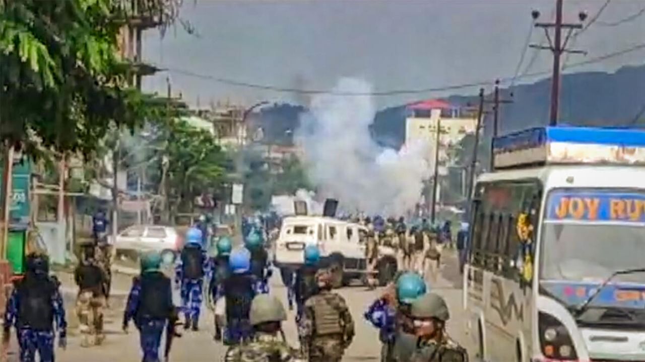 Security forces personnel lob teargas shells to disperse rioters after a mob allegedly attempted to loot weapons from an India Reserve Battalion located in Khangabok, in Thoubal district of Manipur. Credit: PTI Photo