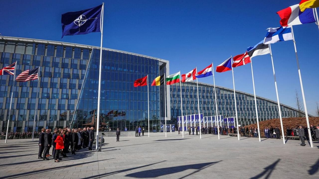 Officials attend a flag-raising ceremony for Finland's accession during NATO foreign ministers' meeting at NATO headquarters in Brussels, Belgium, 04 April 2023. Finland becomes the 31st member of the Alliance on 04 April.  Credit: Reuters Photo