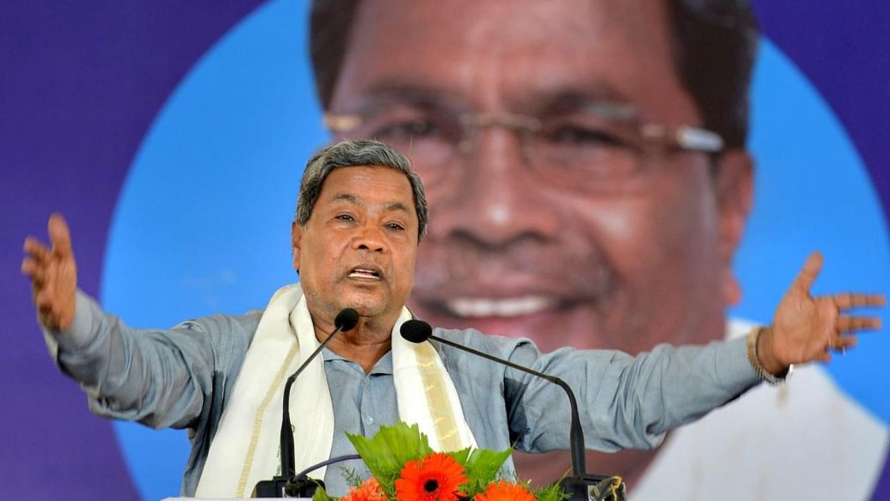 Karnataka Chief Minister Siddaramaiah speaks during the inauguration of the solar panels at "Shakti Sthala", the 2,000 Mega Watt Solar Power Park, in Pavagada Taluk situated about 150 kms from Bengaluru on Thursday. Credit: PTI Photo