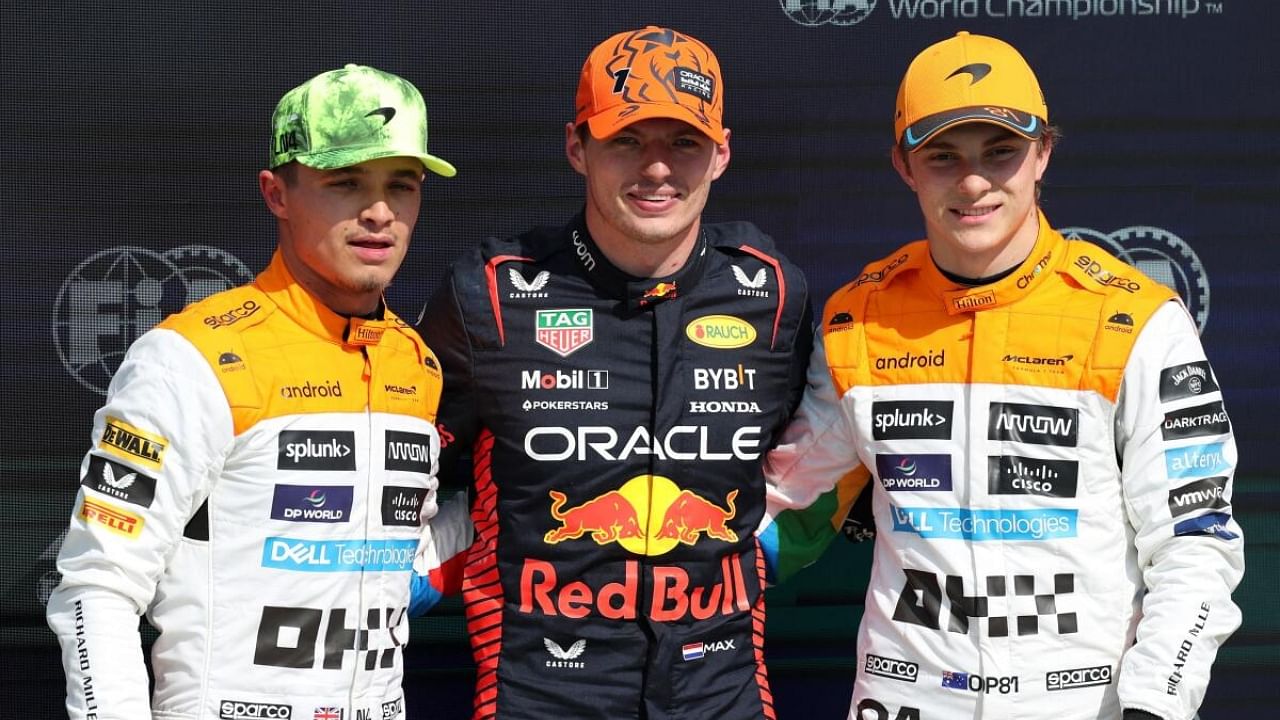 Red Bull's Max Verstappen celebrates after qualifying in pole position alongside second placed McLaren's Lando Norris and third placed McLaren's Oscar Piastri. Credit: Reuters Photo