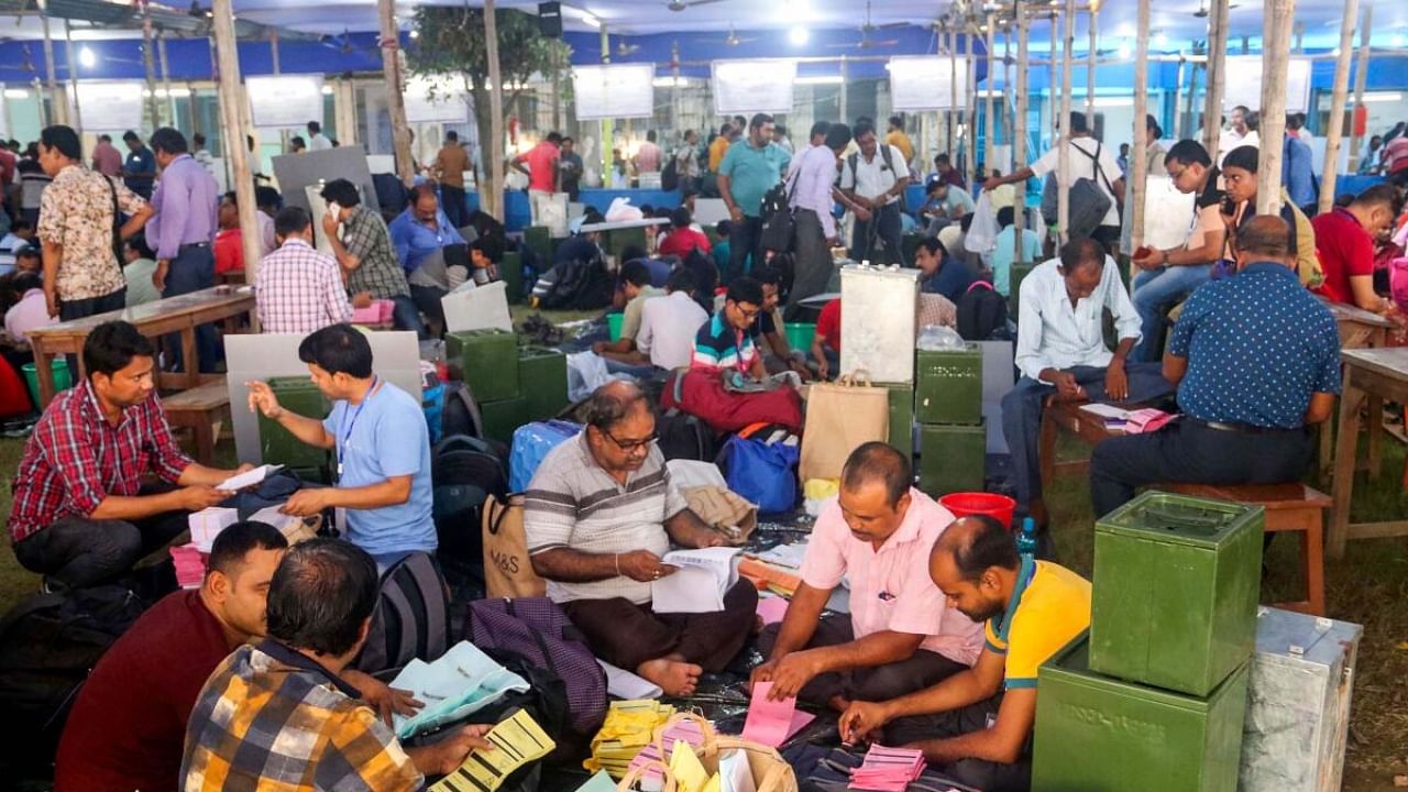 Polling officials collect EVMs and other election material at a distribution centre ahead of the West Bengal panchayat elections, at Balurghat in South Dinajpur district. Credit: PTI Photo