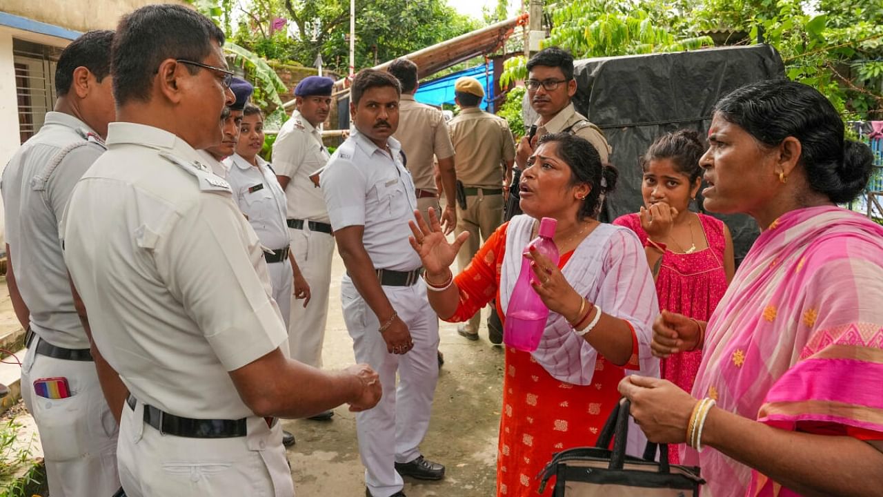 Women voters express their anger to security people outside a polling booth during panchayat elections in North 24 Pargana district of West Bengal. Credit: PTI Photo