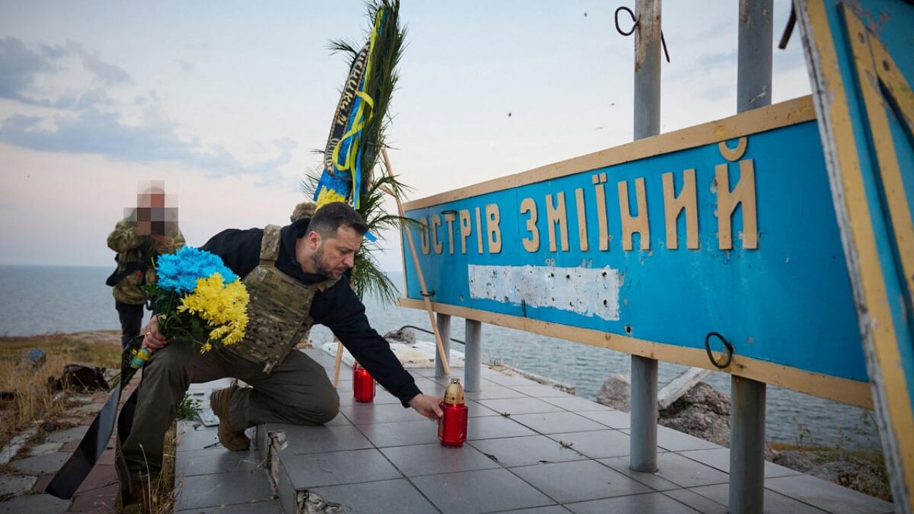 Ukraine's President Volodymyr Zelenskyy pays tribute to fallen defenders of the country as he visits Snake (Zmiinyi) Island in the Black Sea. Credit: Reuters Photo  