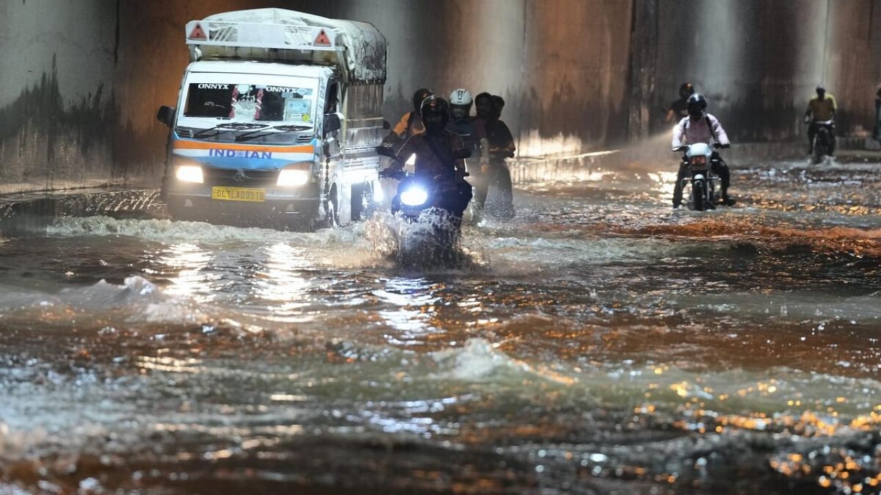 Vehicles make their way under a waterlogged tunnel following heavy monsoon rains, near Appolo hospital, Okhla, in New Delhi. Credit: PTI Photo