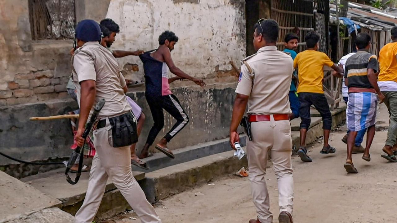 Police personnel baton charge after a clash between rival political groups during panchyat elections, at Nagaria village in Malda district/ Credit: PTI Photo