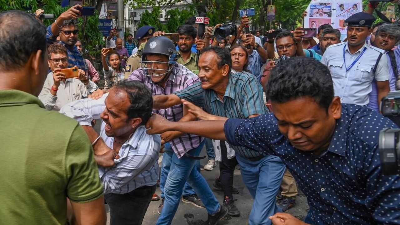 Members of Bharatiya Janata Yuva Morcha being detained at a protest against the alleged violence during West Bengal Panchayat elections, near West Bengal State Election Commission office in Kolkata. Credit: PTI Photo