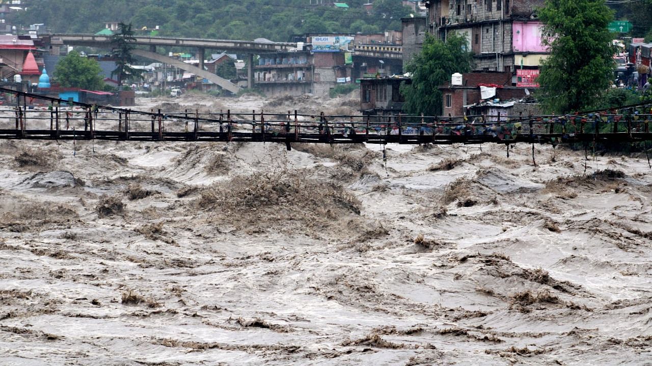 A view shows the overflowing river Beas following heavy rains in Kullu. Credit: Reuters Photo