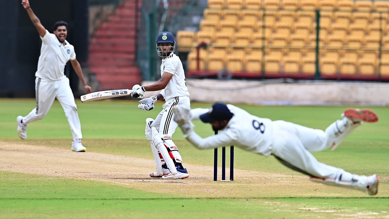 South Zone's Tilak Verma watches as North Zone wicketkeeper Prabhsimran Singh takes his catch on the final day of the Duleep Trophy semi-final match at M Chinnaswamy Stadium in Bengaluru on Saturday. Credit: DH Photo/Pushkar V