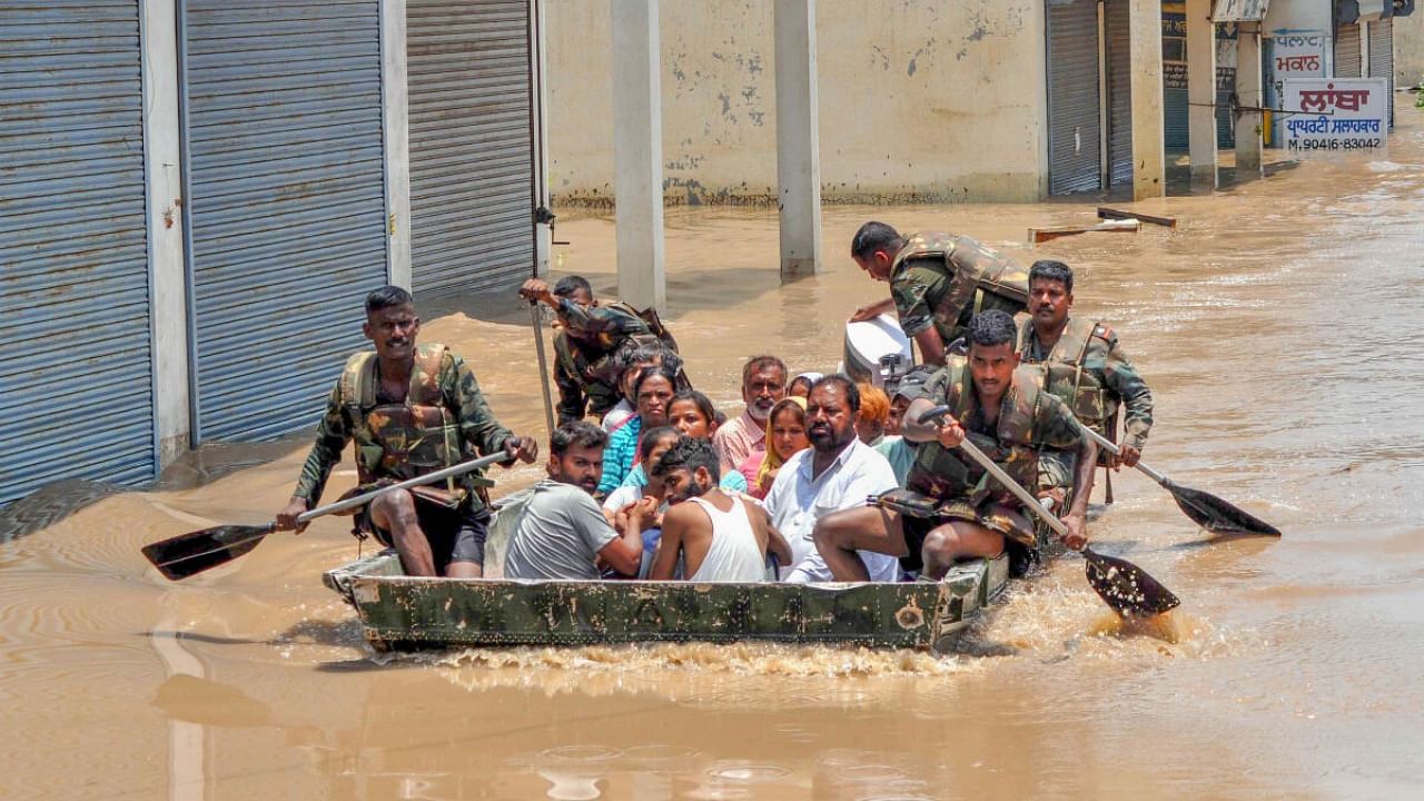 Indian Army personnel rescue people stuck in the flooded Sanauri Adda area after an increase in the water level of Badi Nadi river following heavy monsoon rain, in Patiala, Tuesday, July 11, 2023. Credit: PTI Photo