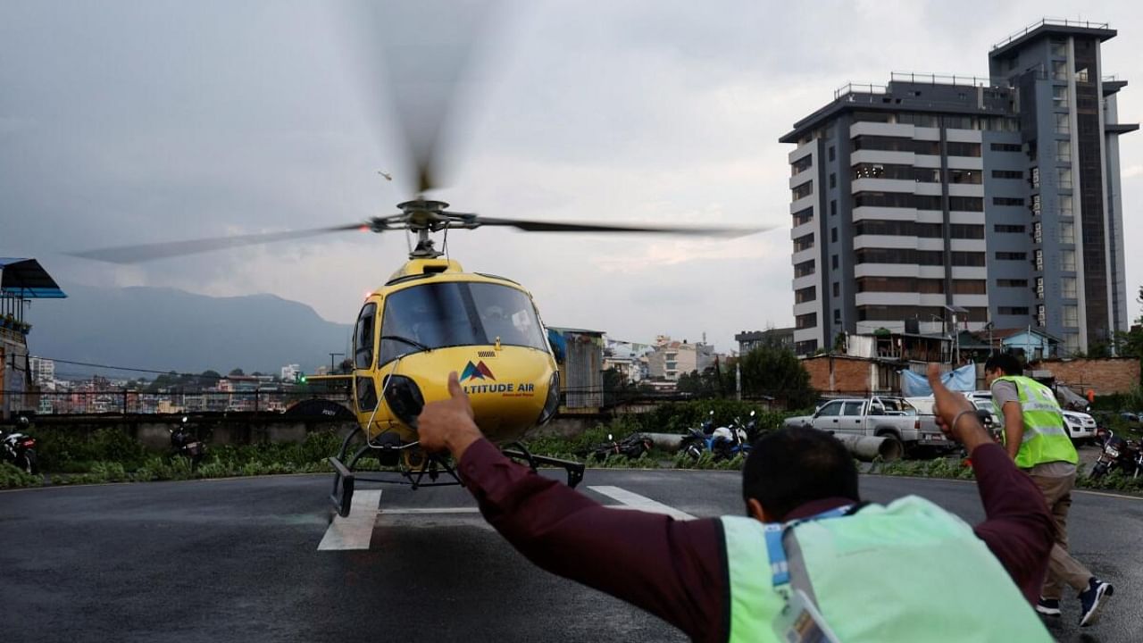 Officials from Manang air rush towards the helicopter carrying the body of the victims killed in a helicopter crash belonging to Manang air, at Tribhuvan University Teaching Hospital in Kathmandu. Credit: Reuters Photo