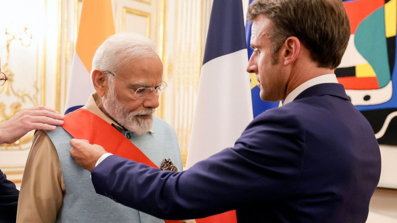  Prime Minister Narendra Modi being conferred with the Grand Cross of the Legion of Honour, the highest award in France, by French President Emmanuel Macron in Paris, Thursday, July 13, 2023.Credit: PTI Photo