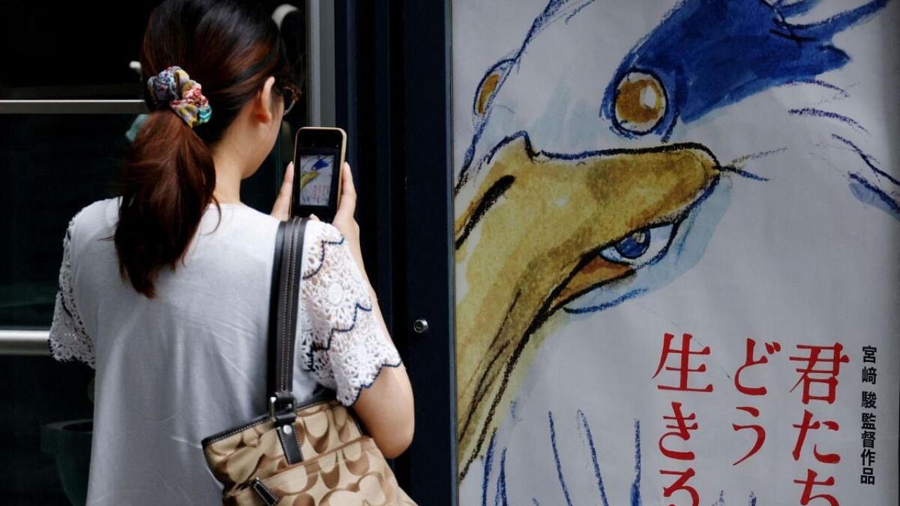 A movie poster of Hayao Miyazaki's film 'How Do You Live?' (Kimitachi wa Do Ikiru Ka?) is displayed outside a movie theatre in Tokyo. Credit: Reuters Photo