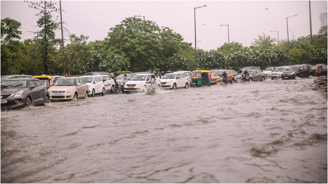 Noida: Vehicles move through a waterlogged road during rain in Noida, Saturday, July 8, 2023. Credit: PTI Photo