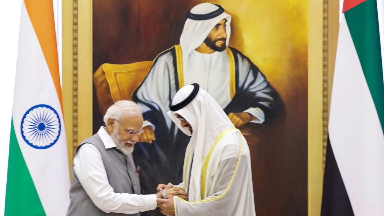 Prime Minister Narendra Modi and UAE President Sheikh Mohamed bin Zayed Al Nahyan exchange 'friendship bands' during a meeting at Qasr Al-Watan, in Abu Dhabi, Saturday, July 15, 2023. Credit: PTI Photo