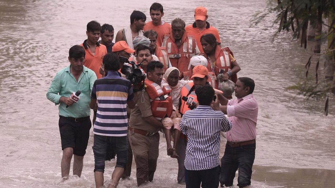 NDRF personnel rescue people stranded in floods in Noida. Credit: PTI Photo